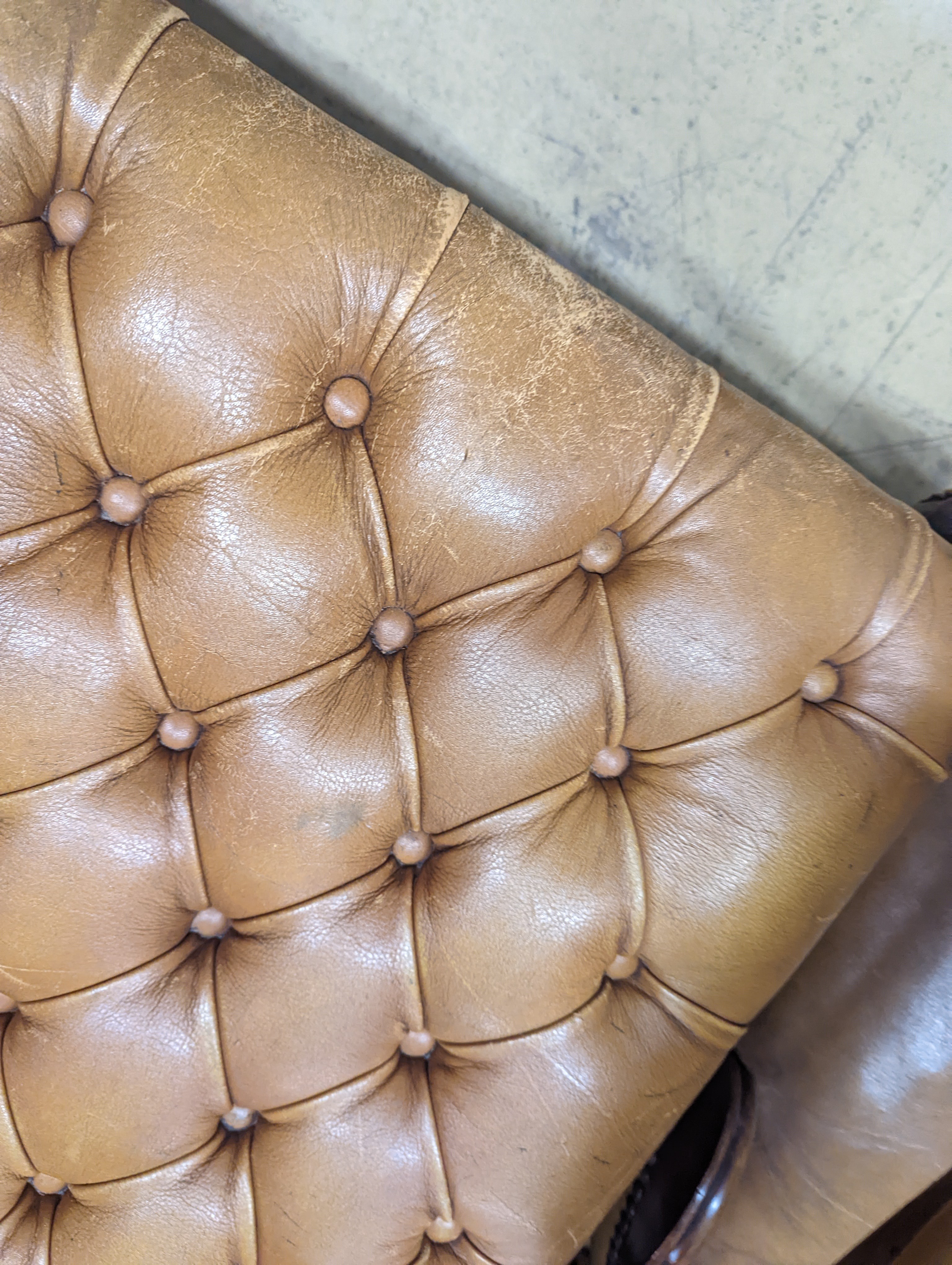 A Victorian carved X-framed rosewood footstool, upholstered in a buttoned brown leather, width 90cm depth 57cm height 42cm